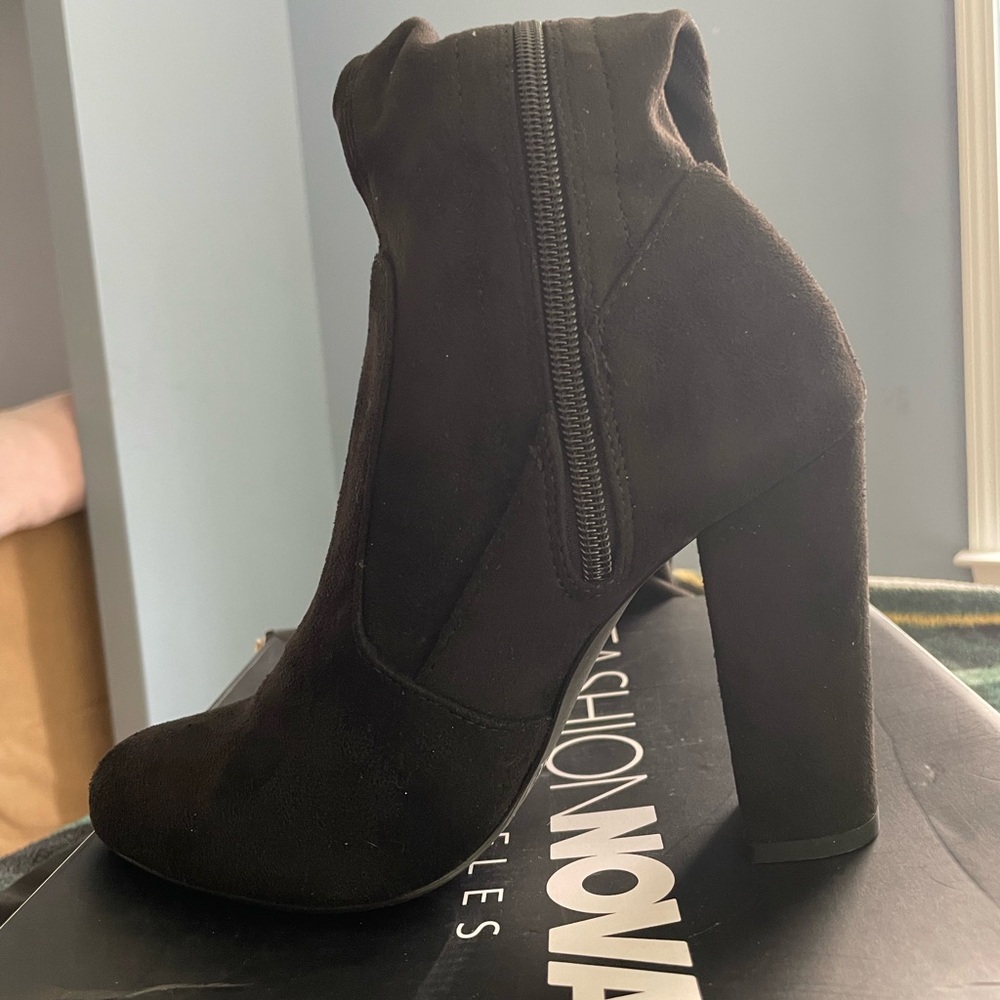 Fashion nova black knee high boots.
